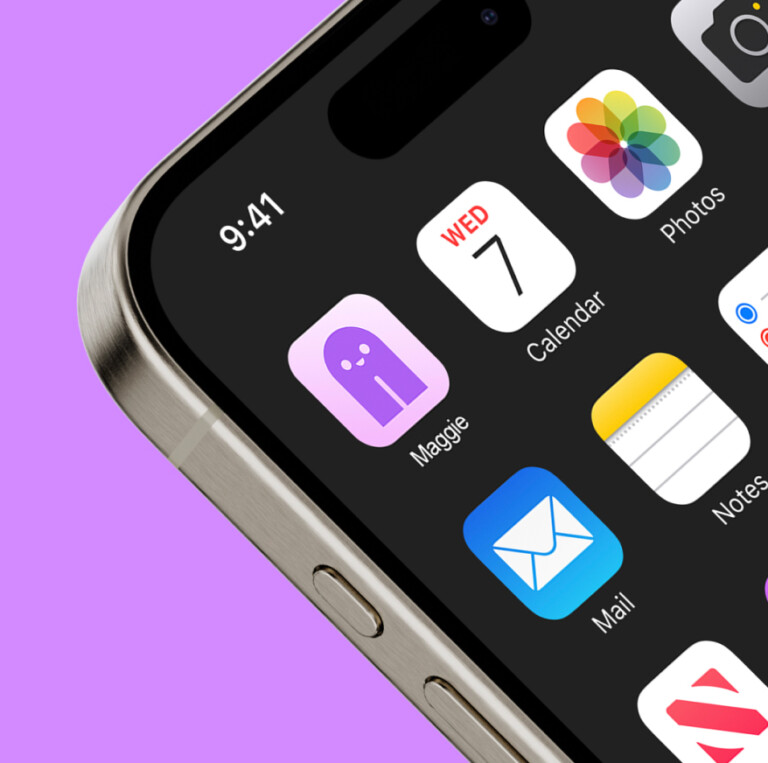 Close-up of an iPhone screen showing a home screen with various app icons, including a purple Maggie app, reflecting a personalised property marketing campaign adapting in real-time against a purple background.