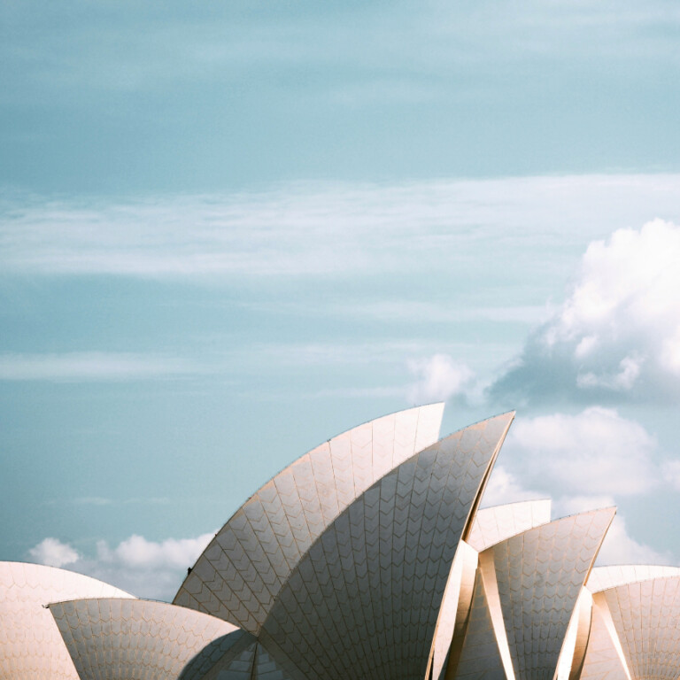 The Sydney Opera House roof sails against a blue, cloudy sky, capturing the essence of a personalised property marketing campaign adapting in real-time.